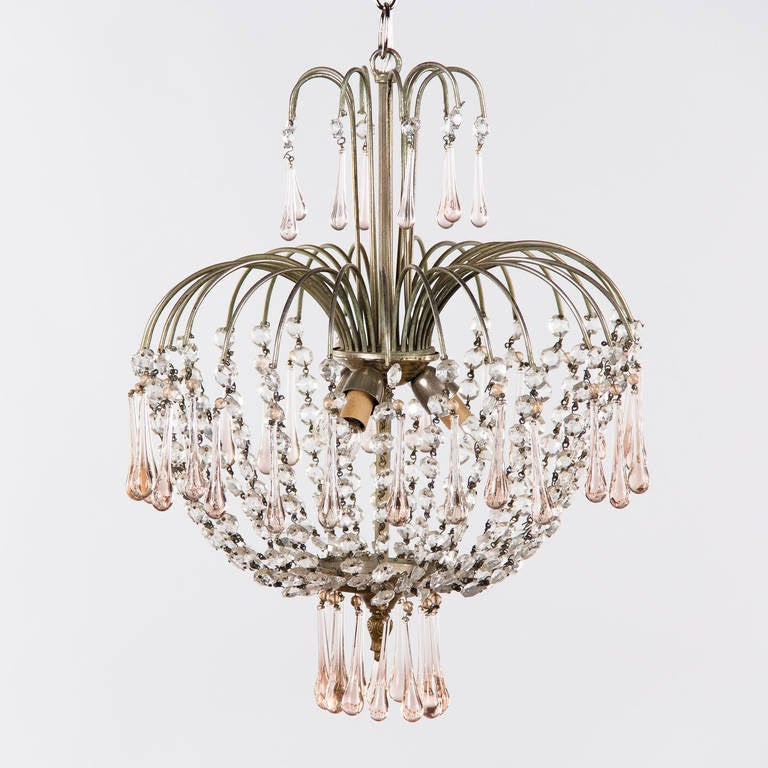 A mid-century Murano chandelier with beaded crystal and light pink glass teardrops. The round caged structure is silver metal. The pendant has three chandelier socket lights. Measure: The adjustable chain and canopy add 20.5".