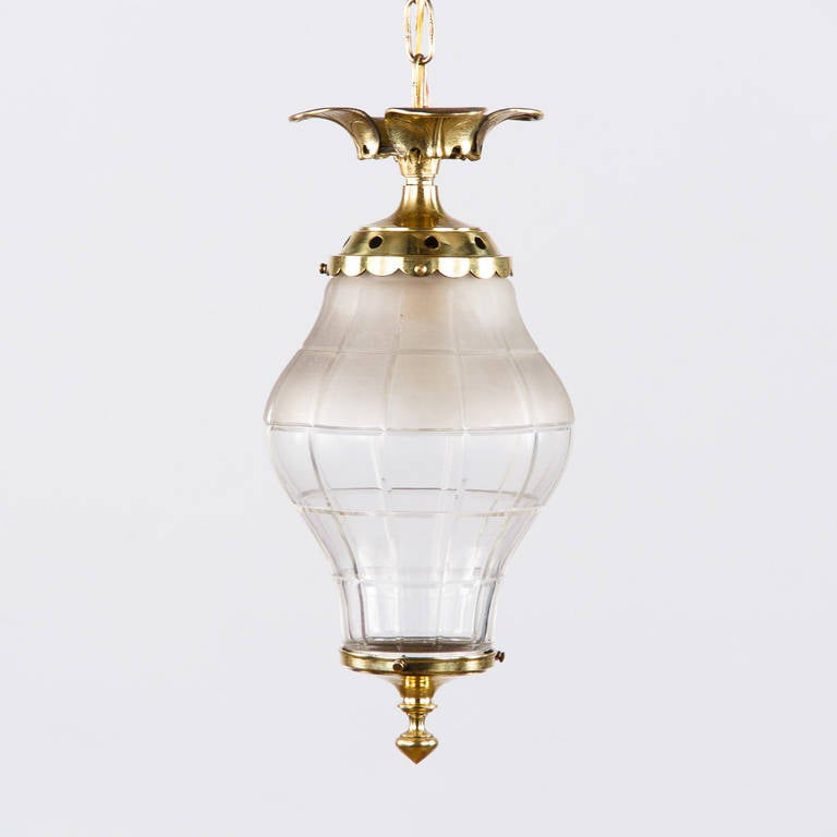 A wonderful lantern from the Art Nouveau Period made of solid brass with leaf motifs. The cut glass fixture is partly frosted and partly clear. The lantern is housing a single regular bulb. The actual adjustable chain and canopy add 27