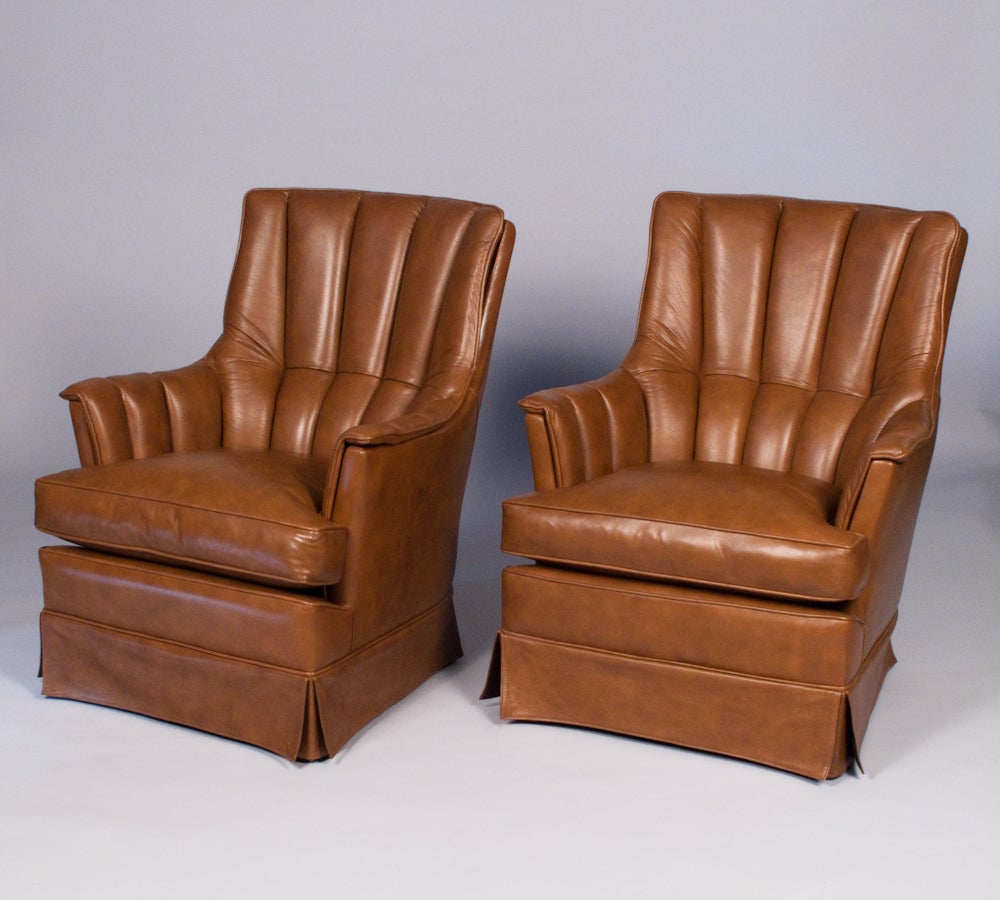 A handsome rich upholstered leather Pair of 1960's Armchairs from Spain.  They are made of soft tobacco brown leather with scalloped backs and removable cushions. A fabulous look and extremely comfortable.