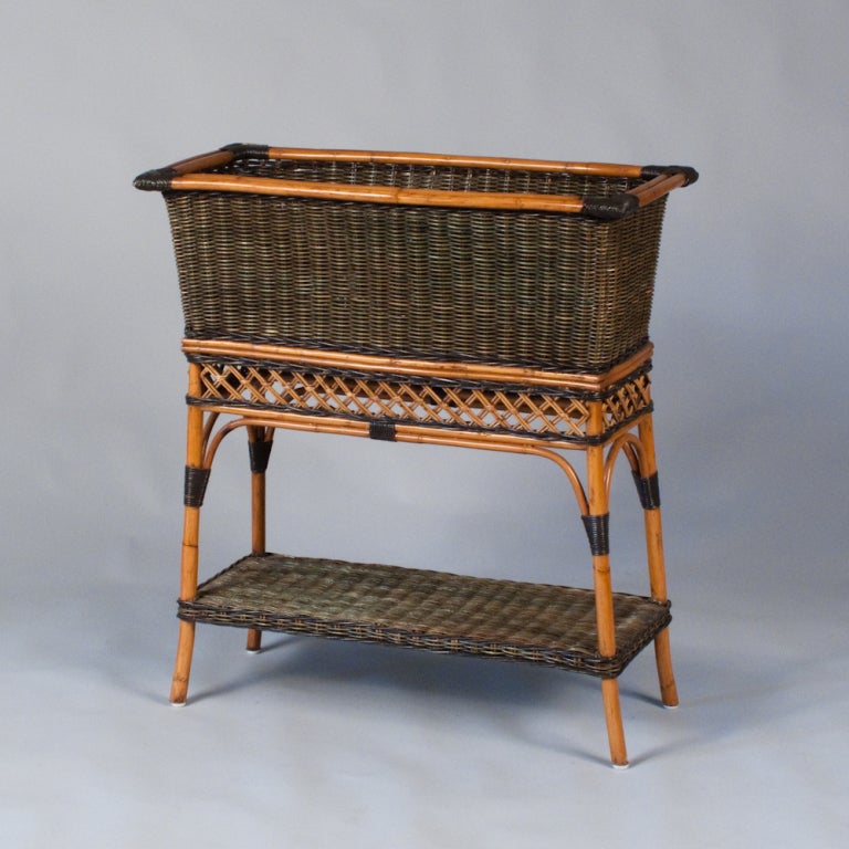 A fabulous French Wicker Jardiniere made by the furniture makers Grange in the 1970's.  It is made in wicker painted green and a faux bamboo frame. The inside top compartment is 9