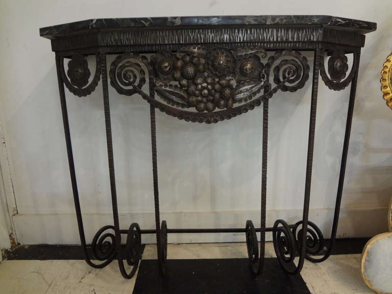 Beautifully detailed Edgar Brandt or Paul Kiss inspired French Art Deco hand forged and hammered wrought iron console table or demilune with original marble top from the 1930s (great size for limited space).
  