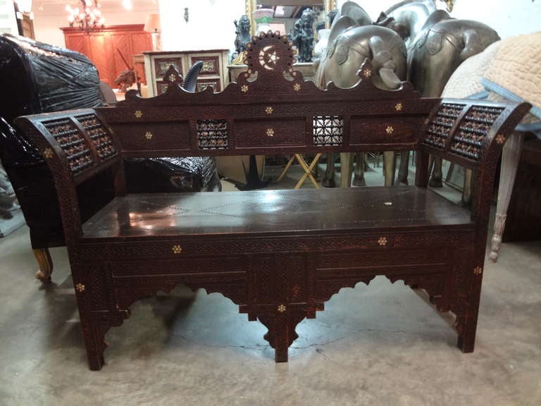 Handsome antique Middle Eastern, Moroccan or Syrian Arabesque Padauk wood bench inlaid with mother of pearl. This antique Moorish or Orientalist bench is in great condition.

