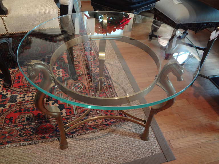 Chic Italian Maison Jansen style brass seahorse cocktail or side table with new star fire glass top. This coffee table can support a much larger glass top if desired.

 