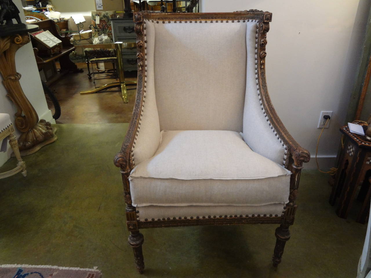 Stylish French Directoire or Neoclassical style gilt wood bergere with soft aged patina.
Newly upholstered in oatmeal linen with down wrapped cushion and spaced French nailhead trim.

Please click KIRBY ANTIQUES logo below to view additional