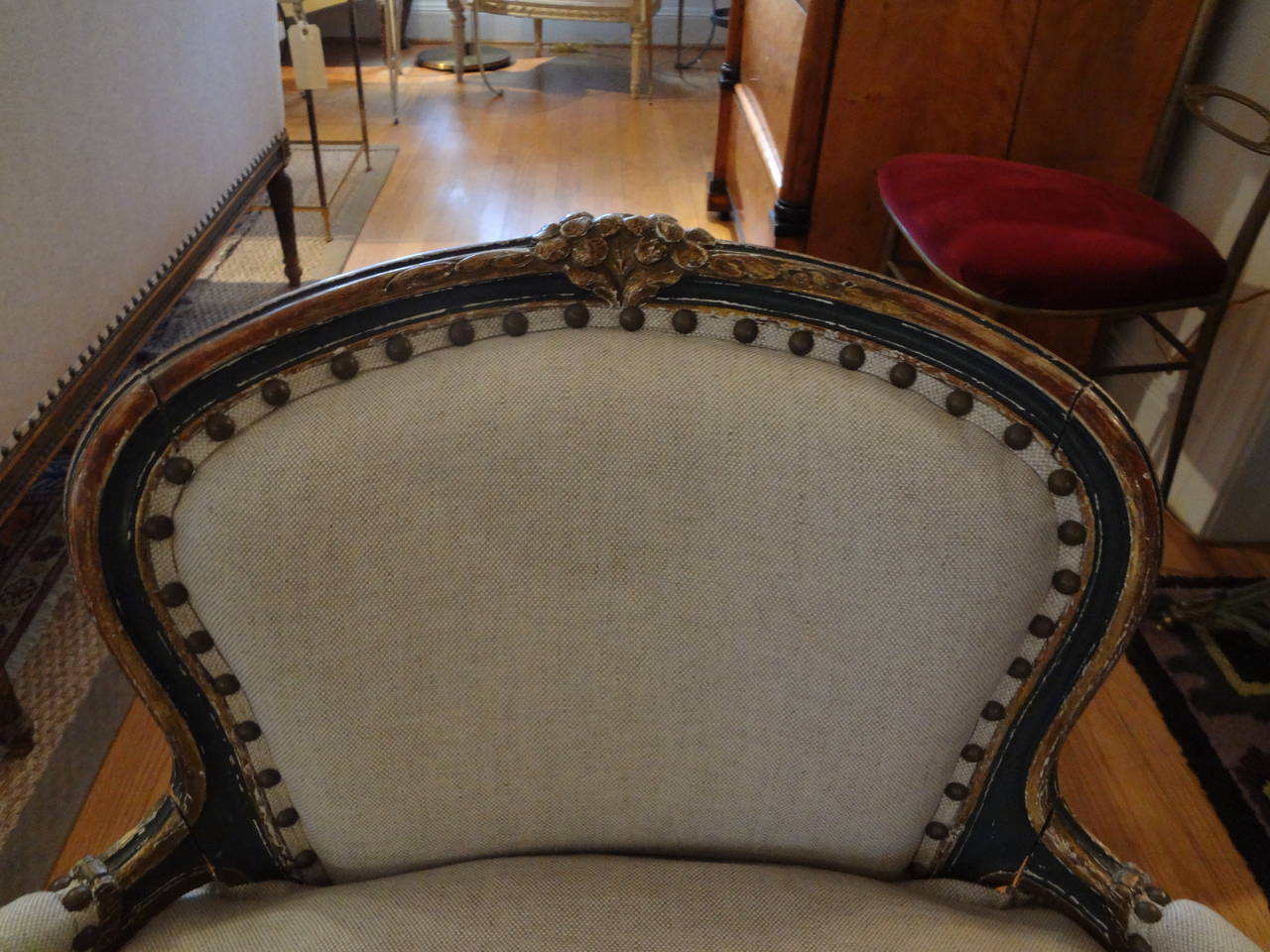 Lovely French Louis XV style painted and gilt petite bergère or children's chair newly upholstered in oatmeal linen with spaced nailhead trim.

Please click KIRBY ANTIQUES logo below to view additional pieces from our vast inventory.