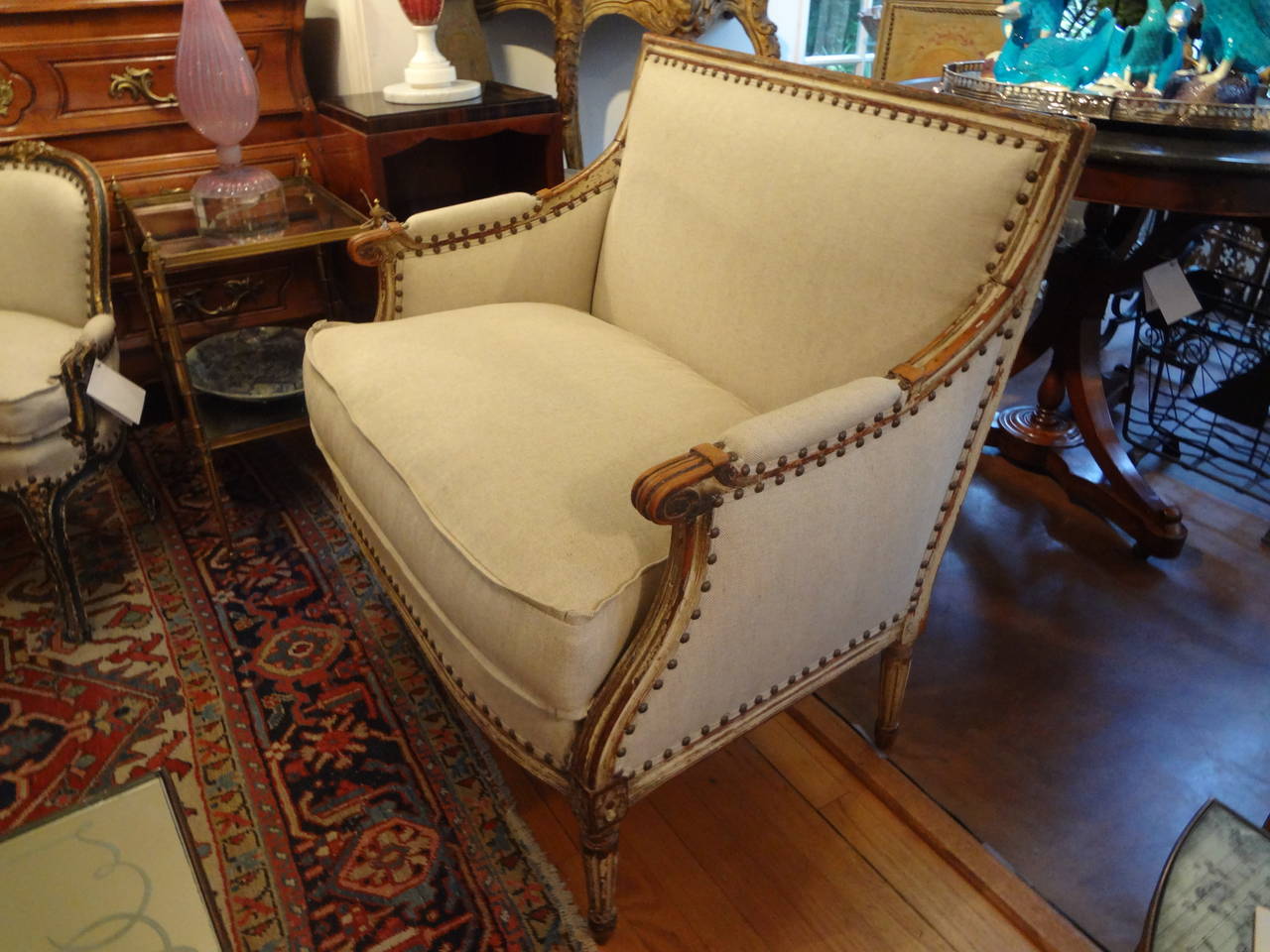 Late 18th early 19th century French Louis XVI painted canapé or bergere chair. Professionally upholstered in oatmeal linen with down wrapped cushion and spaced French brass nailhead detail.  Gorgeous Desirable Patina.

Please click KIRBY ANTIQUES