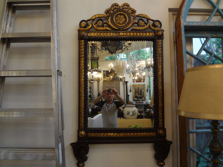 19th century Italian ebonized and giltwood mirror.
Stunning antique Italian ebonized (black) and giltwood mirror. This gorgeous mirror would work well in an entrance hall, above a console table, fireplace mantel, credenza, commode, or buffet. This