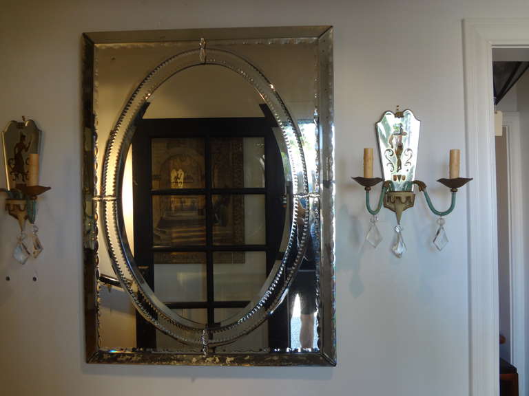 Chic rectangular Venetian mirror with oval center.