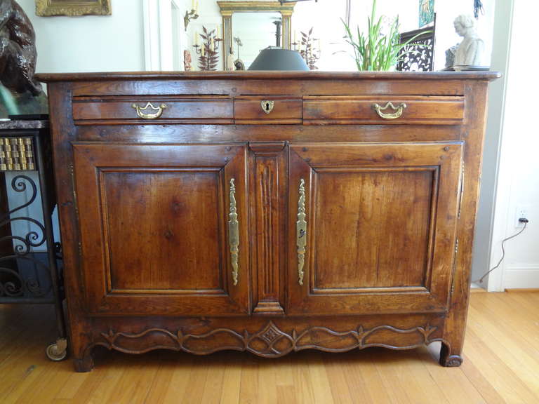 French Louis XIV walnut chest with two doors below and two drawers above from the early 18th century.