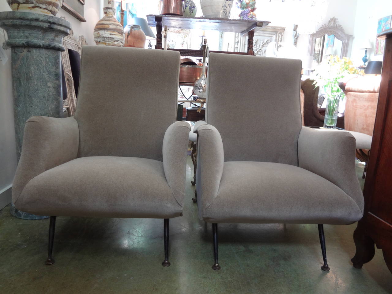 Sleek Pair of Italian Modernist Lounge Chairs in the style of Marco Zanuso for Arflex showing with elegant lines and tapered legs of patinated steel and bronze/brass feet. Taken down to frame and completely reupholstered in taupe mohair like fabric.