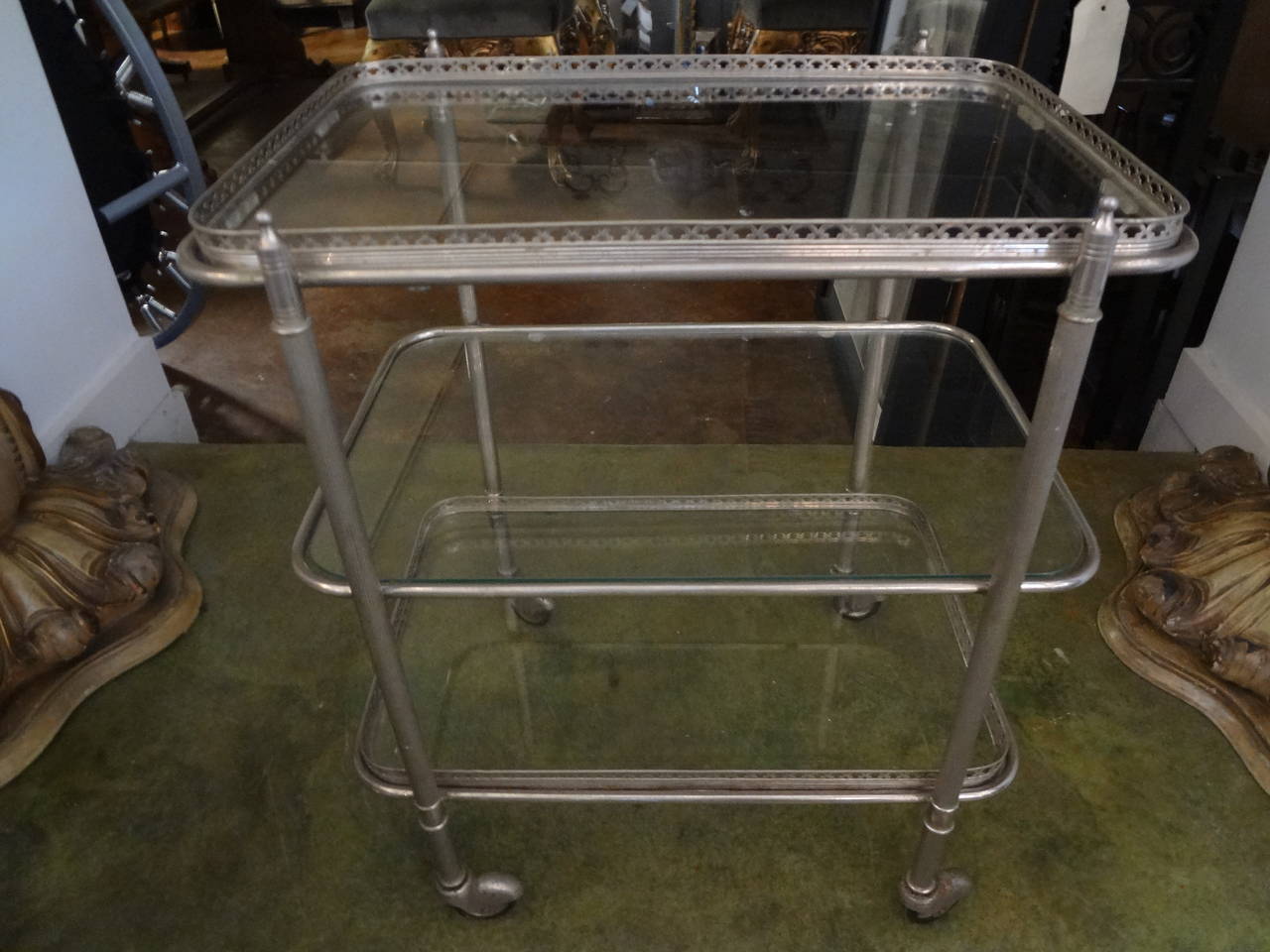 Versatile French Mid-Century Modern nickel-plated drinks or bar cart on casters.

Please click KIRBY ANTIQUES logo below to view additional pieces from our vast inventory.

           