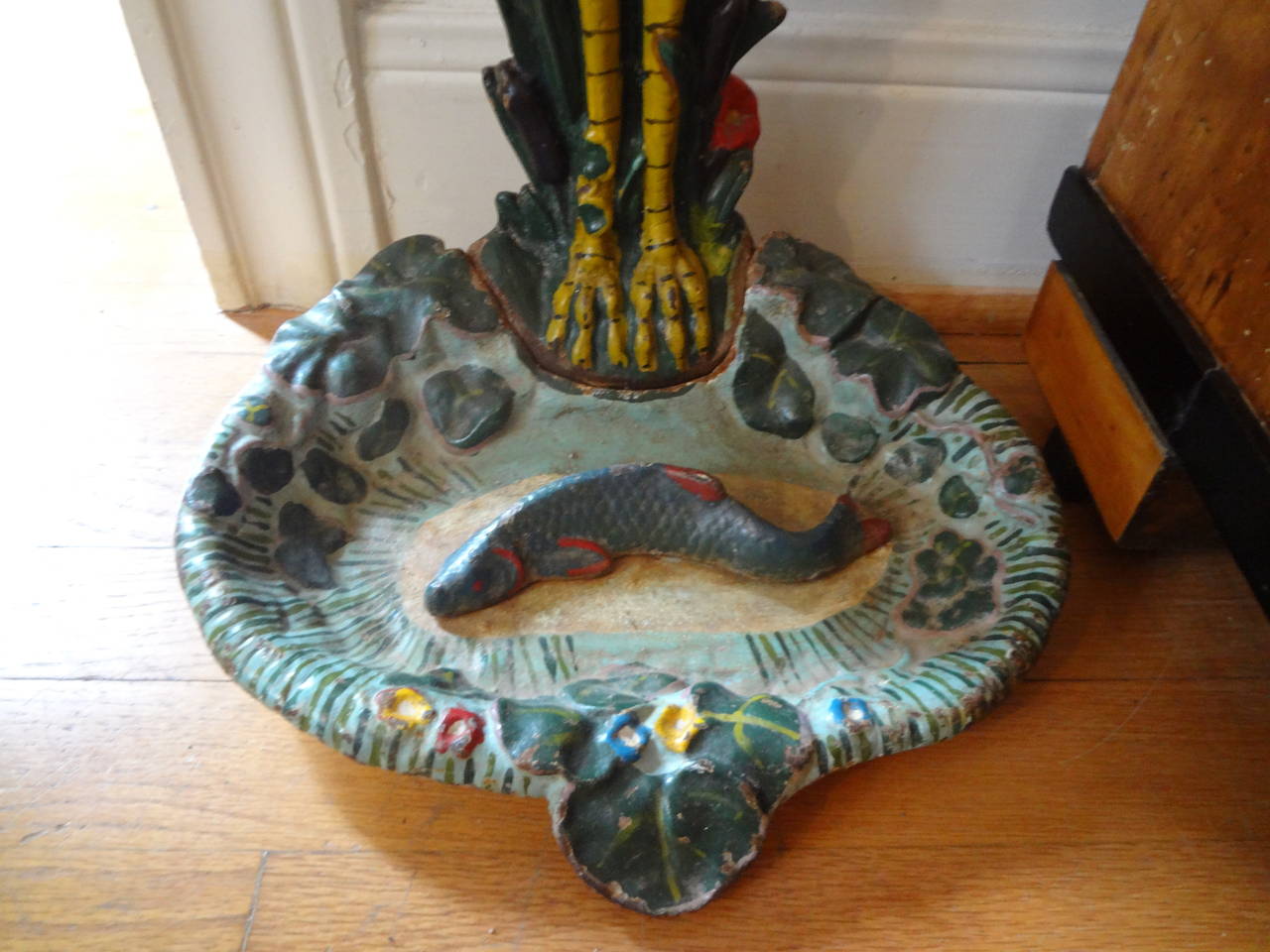 Finely detailed and painted whimsical French cast iron stork umbrella stand terminating in a pond of water with lily pads and a fish.

Please click KIRBY ANTIQUES logo below to view additional pieces from our vast inventory.