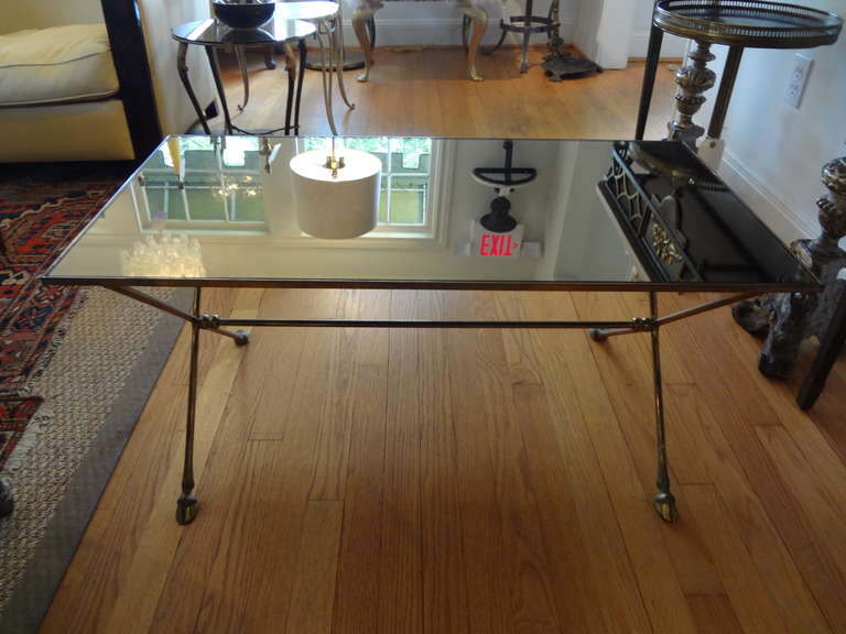 Chic French Maison Bagues/Maison Jansen Directoire style bronze/brass cocktail table with hoof feet and mirrored top, circa 1940.

 