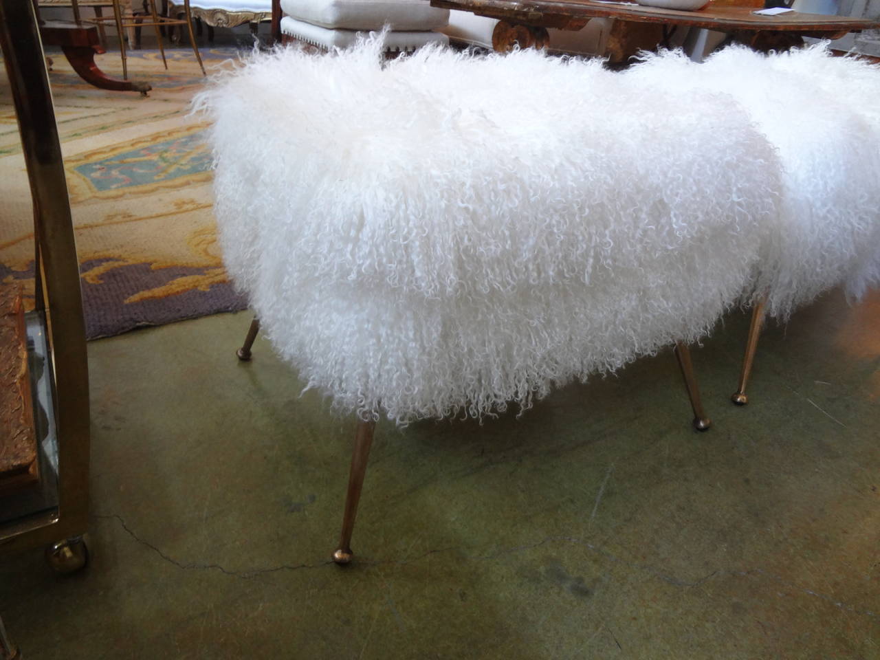 Chic pair of Italian Mid-Century Modern bronze stools newly upholstered in Mongolian lambs wool.

Please click KIRBY ANTIQUES logo below to view additional pieces from our vast inventory.