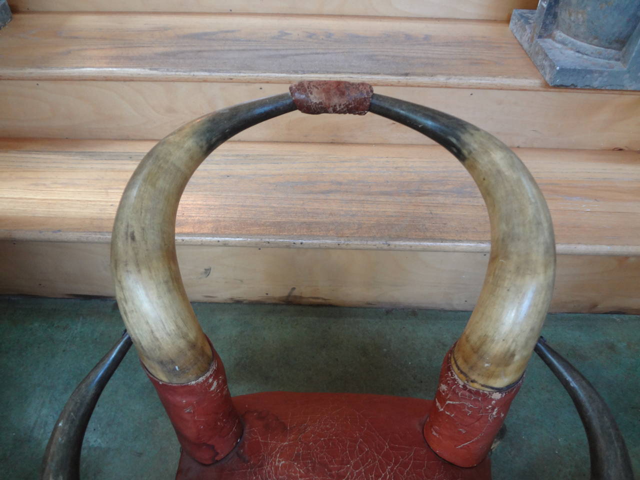 Antique children's Horn chair upholstered in leather.
Great children's chair or child's horn chair with beautifully distressed leather upholstery and brass nail head trim. This unusual antique horn chair would work well in a variety of interiors and