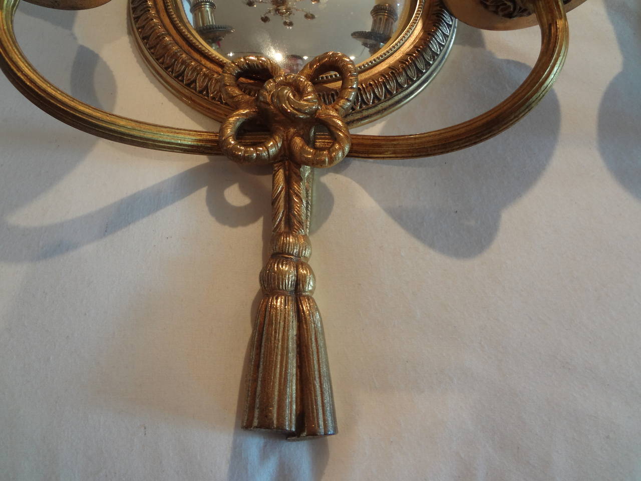 Lovely pair of French Louis XVI style bronze two-light sconces with convex mirrors, signed Petitot, Circa. 1940 (newly wired for U.S. market).

 
 