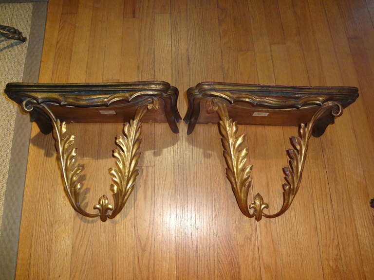 Large well made pair of Italian palladio gilt iron and wood wall consoles or brackets from the 1940s.

Please click KIRBY ANTIQUES logo below to view additional pieces from our vast inventory.

