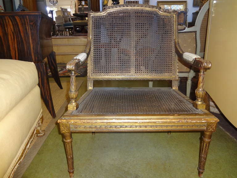 19th century French Louis XVI style giltwood children's chair.
Antique French Louis XVI style gilt wood and cane children's chair or child's chair from the 19th century. This French giltwood children's chair would look great beside a bed for