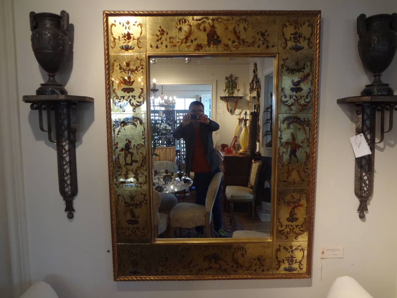 Chic French Maison Jansen or Robert Pansart inspired reverse painted rectangular gilt églomisé mirror with commedia dell'Arte design border. Measures: 51 x 38.

Maison Jansen was a Paris-based interior decoration office founded in 1880 by