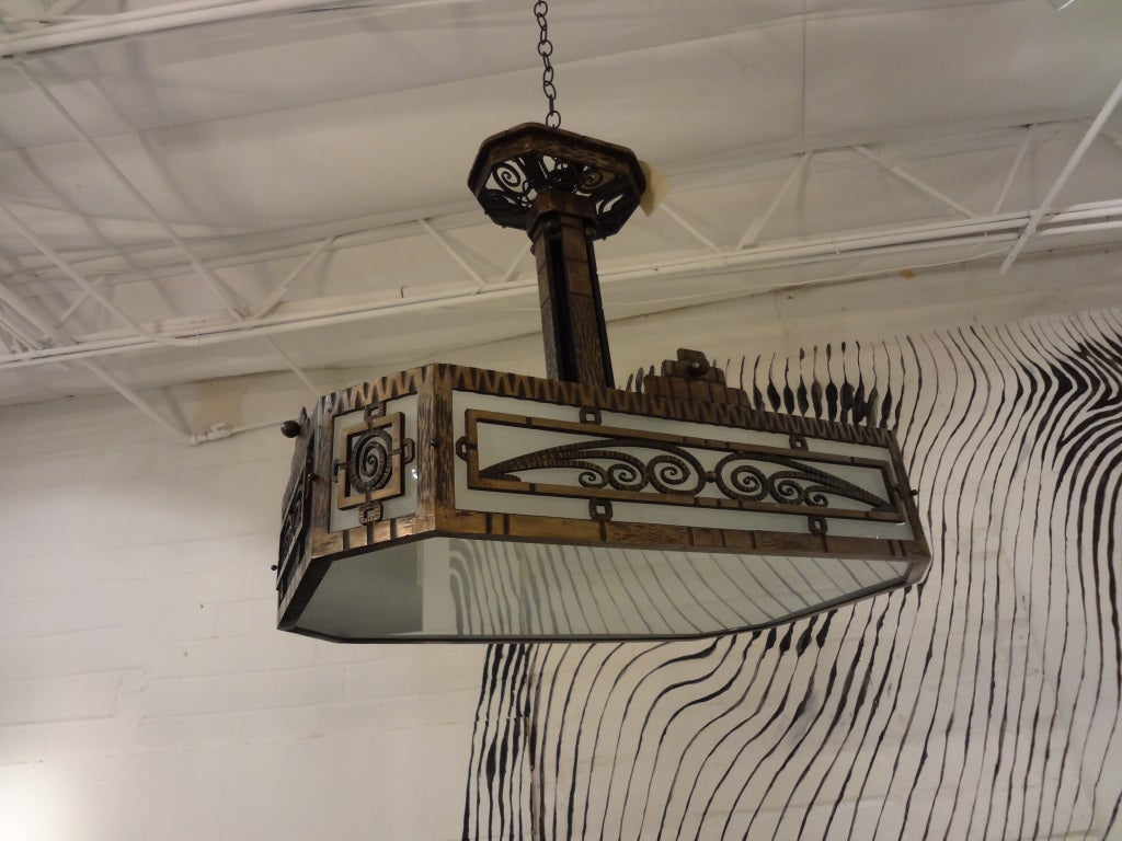 Handsome period French Art Deco wrought iron chandelier by Charles Piguet, newly wired.

Please click KIRBY ANTIQUES logo below to view additional pieces from our vast inventory.