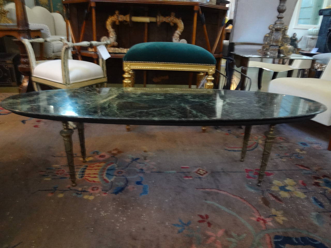 Chic Italian Mid-Century Modern Hollywood Regency coffee table or cocktail table or low table with neoclassical brass legs and a marble top.
This is a great example of Italian midcentury.


  