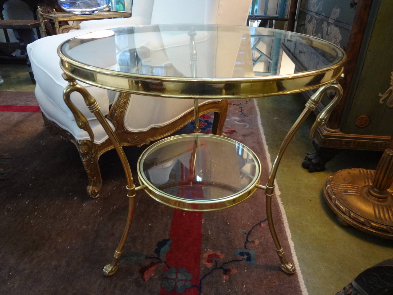 Versatile Italian Hollywood Regency or Mid-Century Modern brass and glass table, side table, drink table, cigarette table or guéridon with swans. This Maison Jansen inspired table is the perfect side table!
 