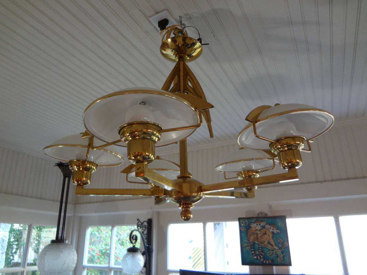 Unusual Italian Mid-Century Modern Stilnovo style five-light brass chandelier with glass shades. This Italian Mid-Century Modern brass chandelier has been newly wired for the U.S. market.
This fixture can be used flushmount for use on homes with