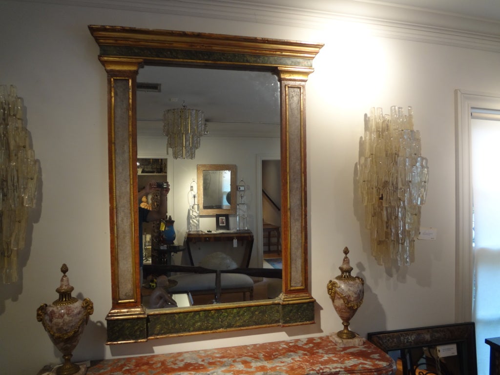 Antique Italian neoclassical style faux marble and giltwood mirror.
Interesting 19th century Italian neoclassical style faux painted and giltwood mirror with columns. The subtle faux marble on this mirror is extremely realistic. This versatile