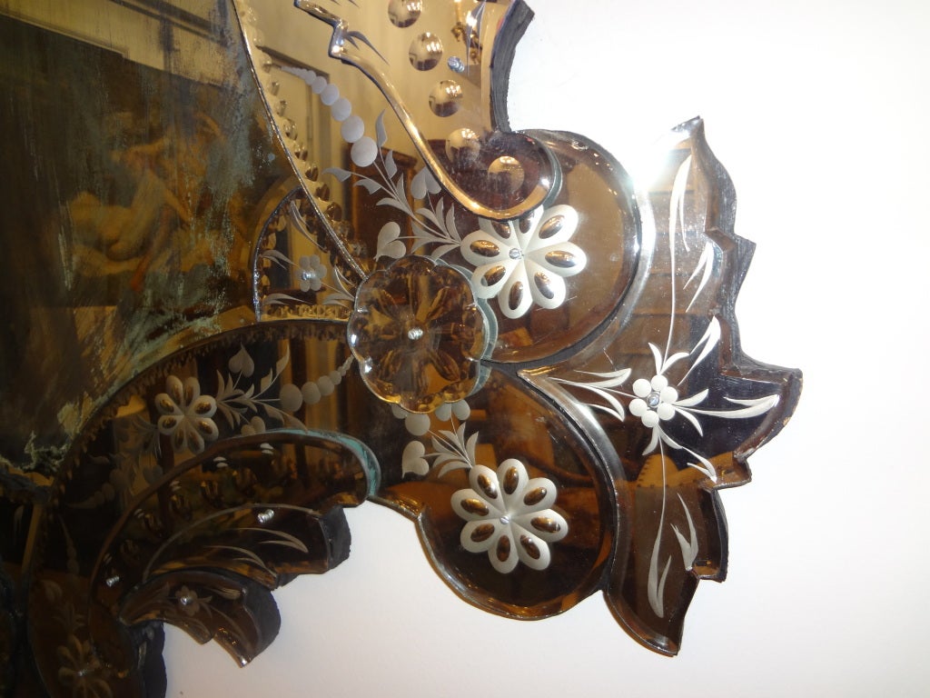 Grand Venetian mirror with darker beveled mirror in center.  

 