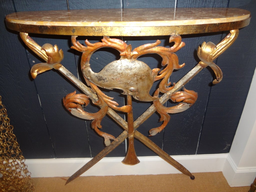 Italian wrought iron and marble console table. Midcentury Italian armorial patinated wrought iron wall mount console table. This vintage Italian console table comes with its beautiful original marble top. Our Hollywood Regency Italian console table