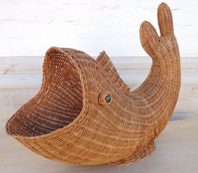 Charming 1970's Italian wicker whale magazine holder with large glass marble eyes. Would also be a wonderful holder for rolled up towels in a powder room!  