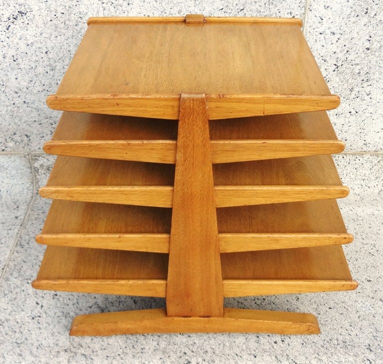 Sculptural Edward Wormley for Dunbar magazine rack with a soft golden mahogany color, and all original finish.  This is an early example with the Dunbar branded logo, C. 1940's.  A beautiful modernist design, with a prototypical forward thinking