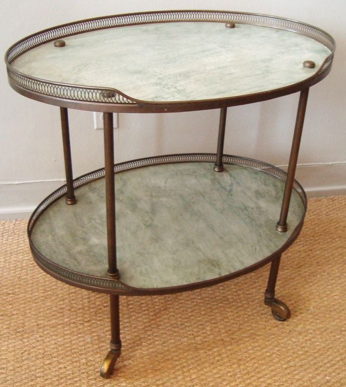1940's Italian bronze and marble bar cart, with thick greyish green marble slabs, and nice dark patinated bronze hardware.  Two tiers, with partial reticulated gallery and bronze covered castors.  Marble has beautiful graining and original honed