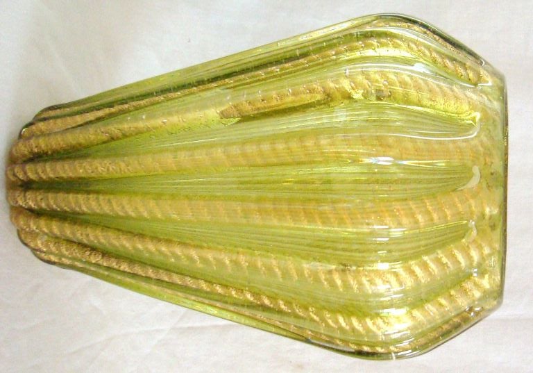 Wonderful tall green and gold Barovier glass vase from the Cordonato D'oro line with deeply ribbed sides and exaggerated twisted rope-like gold inclusion.  Retains its original Camer Glass import label on the bottom.  Camer worked with the better