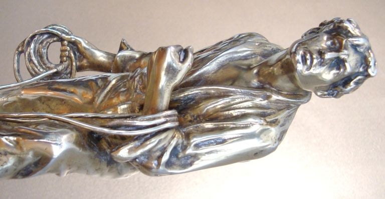 Fabulous and rare large scale sculptural silvered bronze inkwell by Austrian artist, J. Valenta.  This piece dates to C. 1910, and has a narrative nautical theme of a weary boatsman or fisherman struggling to moor his boat to a tree stump, which