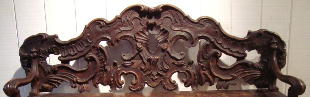 Stunning rare carved walnut bench, in the Rococo style, Venice, 18th C.  This piece retains its original untouched finish and has acquired a glorious patina.  Great graphic form, with all over hand carved deep relief.  This piece is quite sturdy and