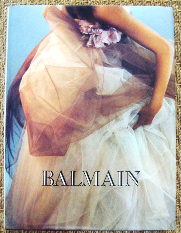 Ultra scarce monograph book about legendary, French 20th century couturier Pierre Balmain. Filled with copious pages of beautiful color photographer of the designer's work. Multiple copies available at $1000 each.