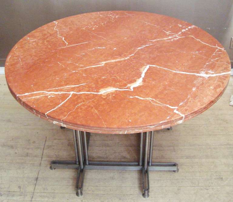 Exceptional 1970s French Rouge Marble and Cast Steel Dining Table

Sensational custom 1970s French dining or center table that we feel was architect-designed and used for a high end commercial space somewhere, probably Paris. The gorgeous rouge