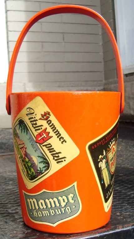 1950's German bright orange lacquered papier mache ice bucket with decoupaged wine labels.  Marked Made in Western Germany on the bottom.