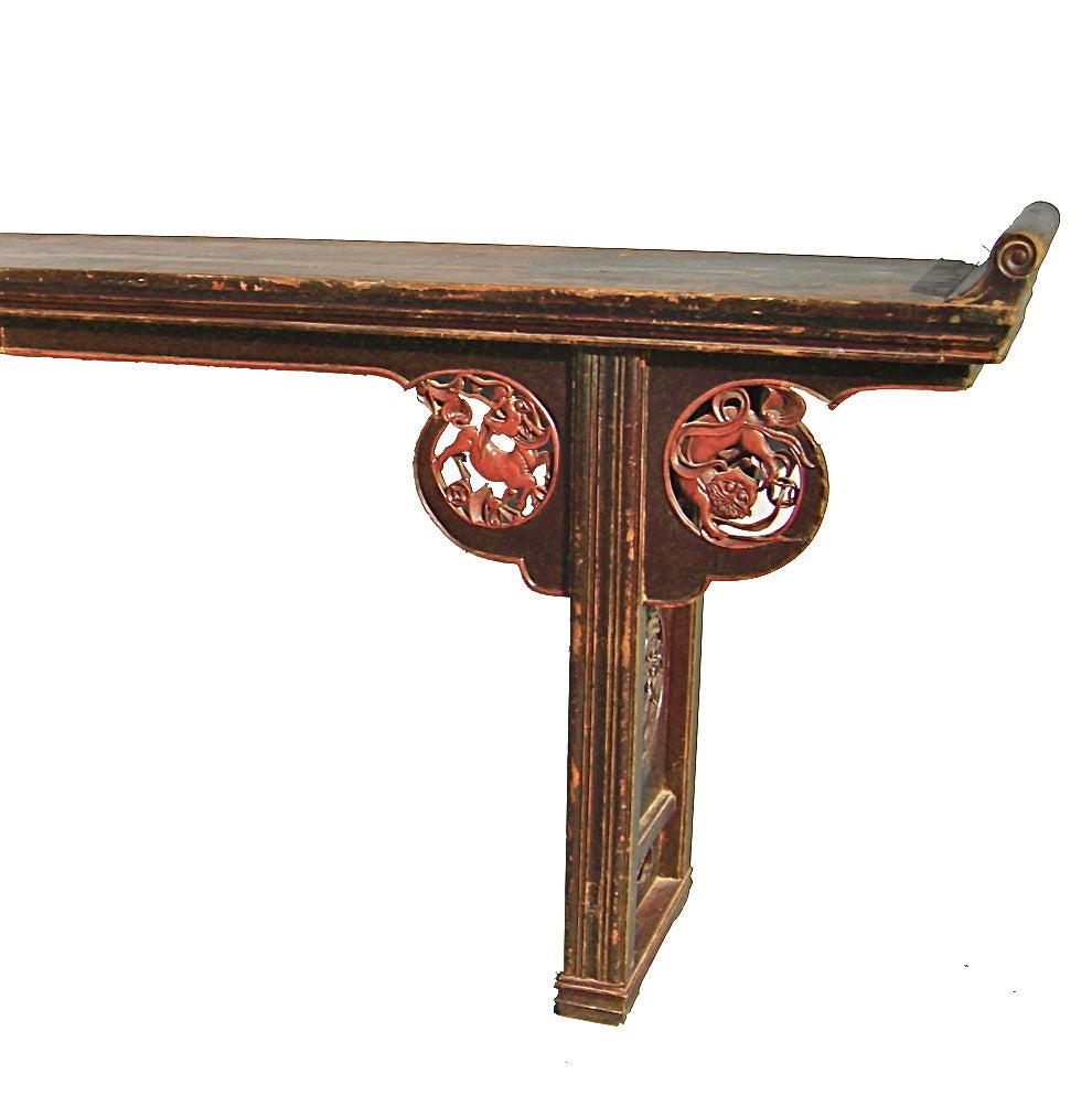 Elmwood scroll top altar table, magnificent carving accented in colored lacquer, 19th century.