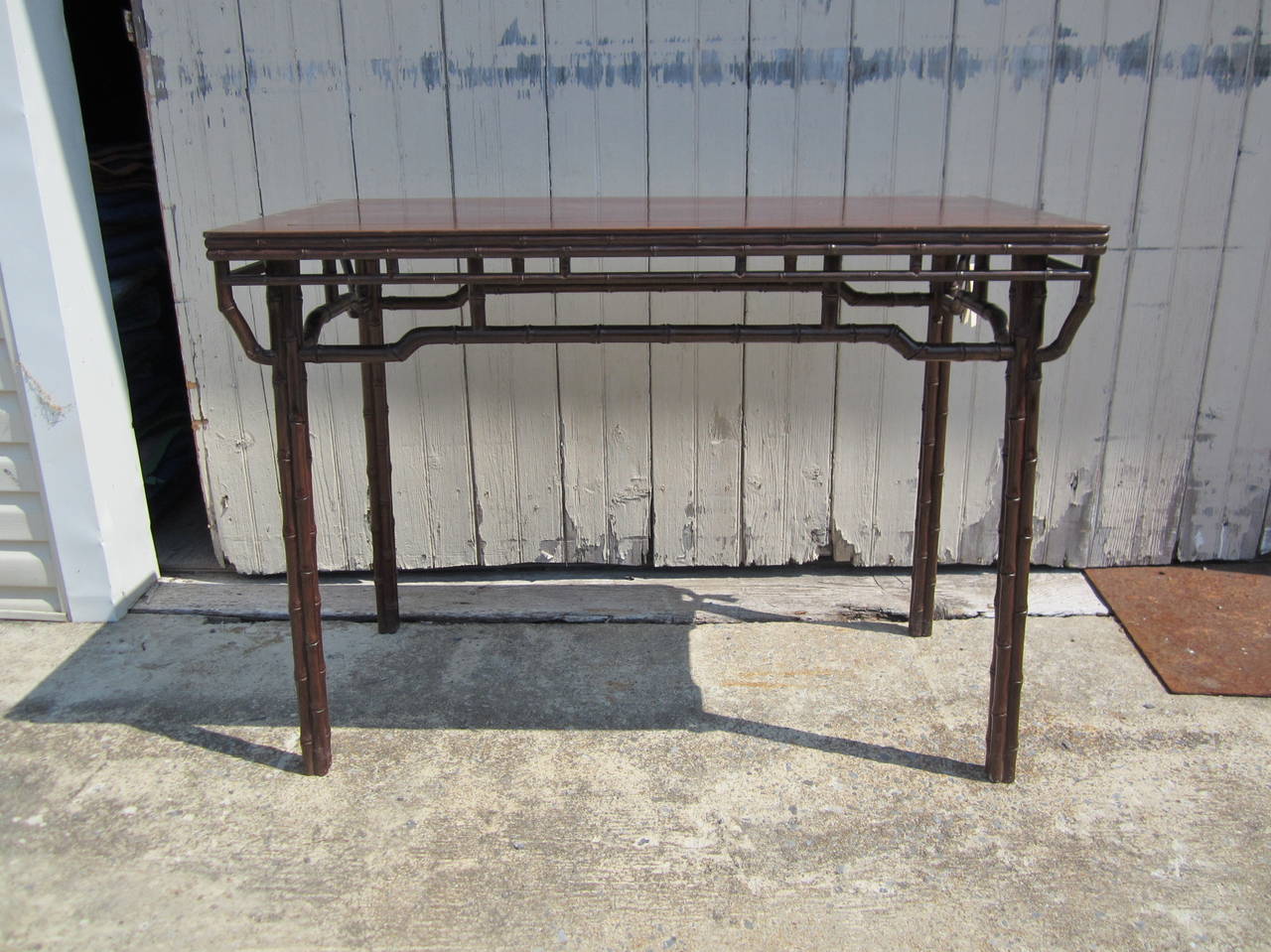 Very finely made side table with faux bamboo carved iron wood. Beautiful patina and excellent condition.