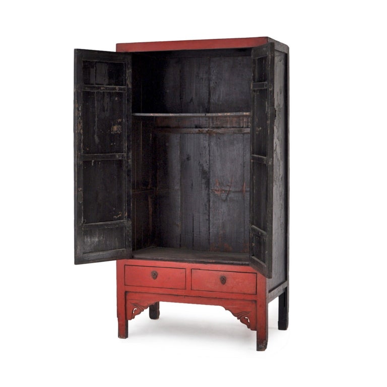 Square cornered Chinese cabinet with two drawers in the original red lacquer finish. A decorative,stately wardrobe/armoire, or bookcase offering ample storage.