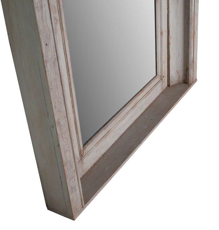 A grey painted carved wood trumeau with new mirror.