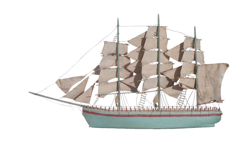 A blue painted model of a sail boat
