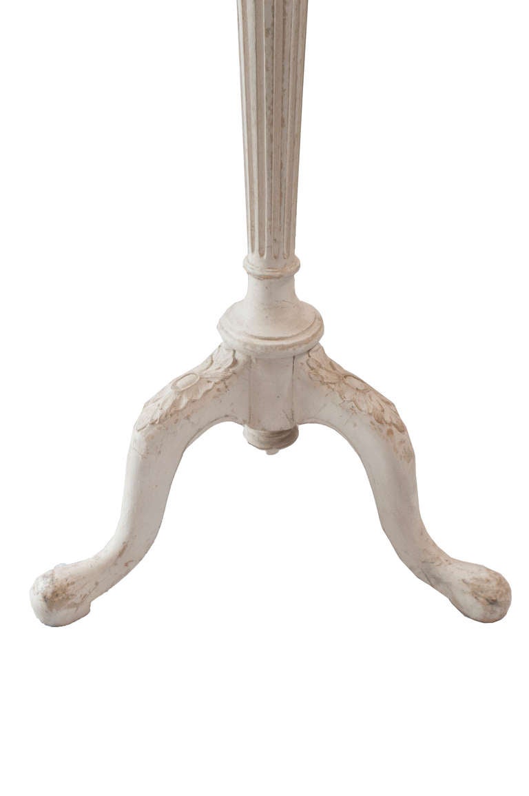 A light grey painted floor lamp
