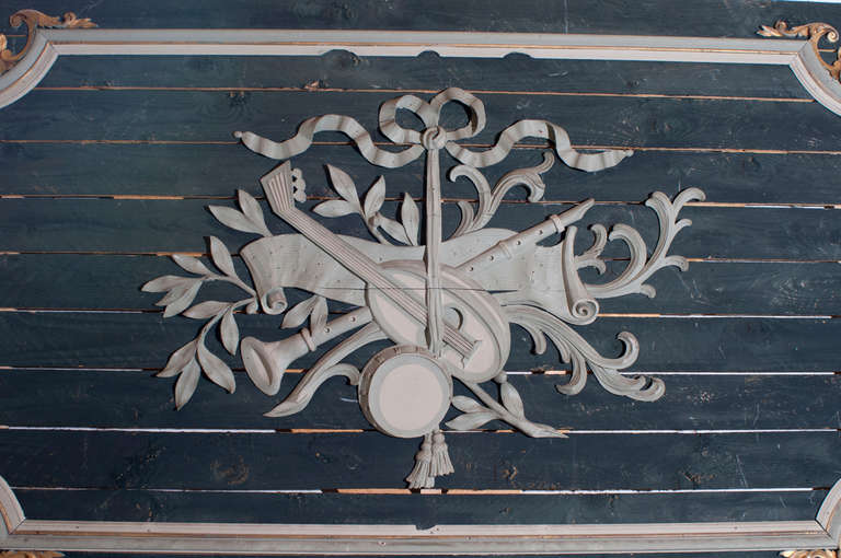A carved wood fragment of a boiserie panel with a new backing panel