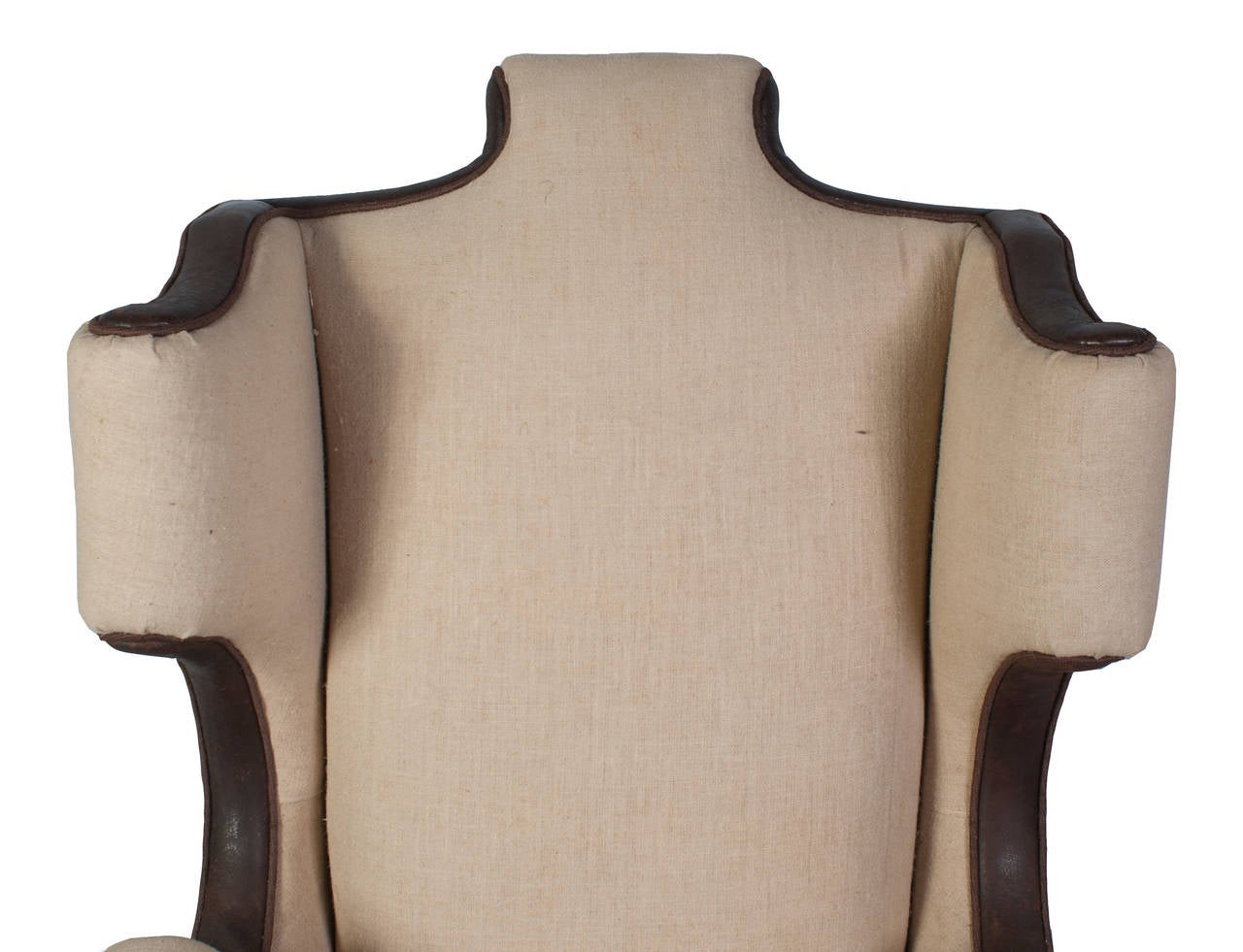 A single linen and leather trim wing chair.