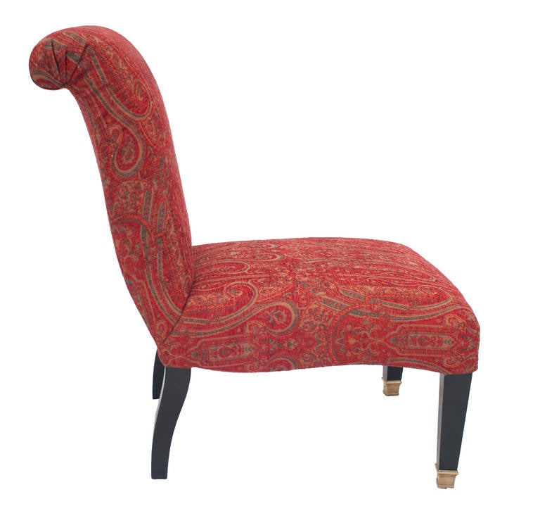 A pair of "Jansen" slipper chairs with brass caster legs and covered in a red,
Paisley fabric.  Seat Depth 20.25