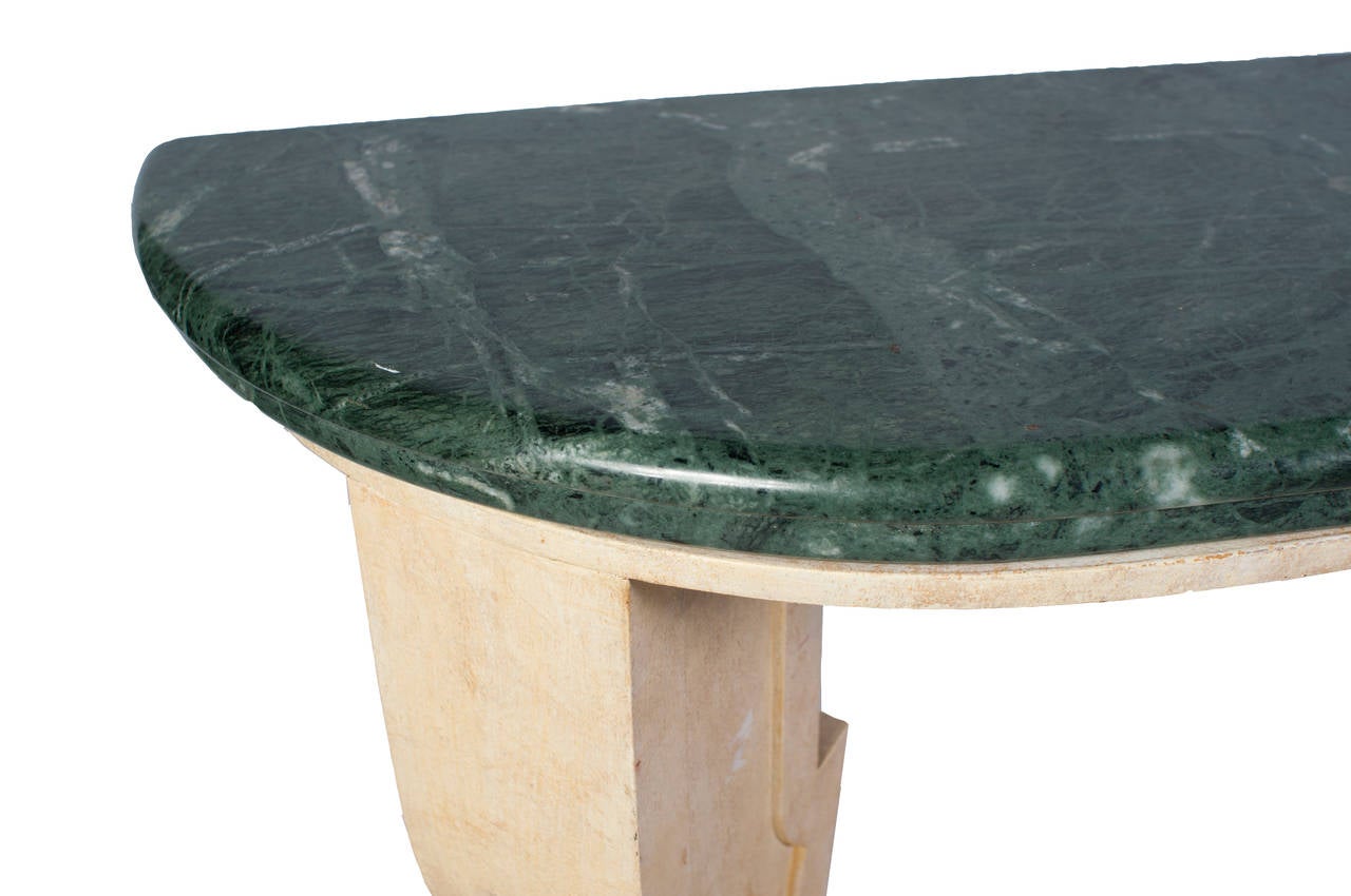 An Art Deco console table with a green marble top.