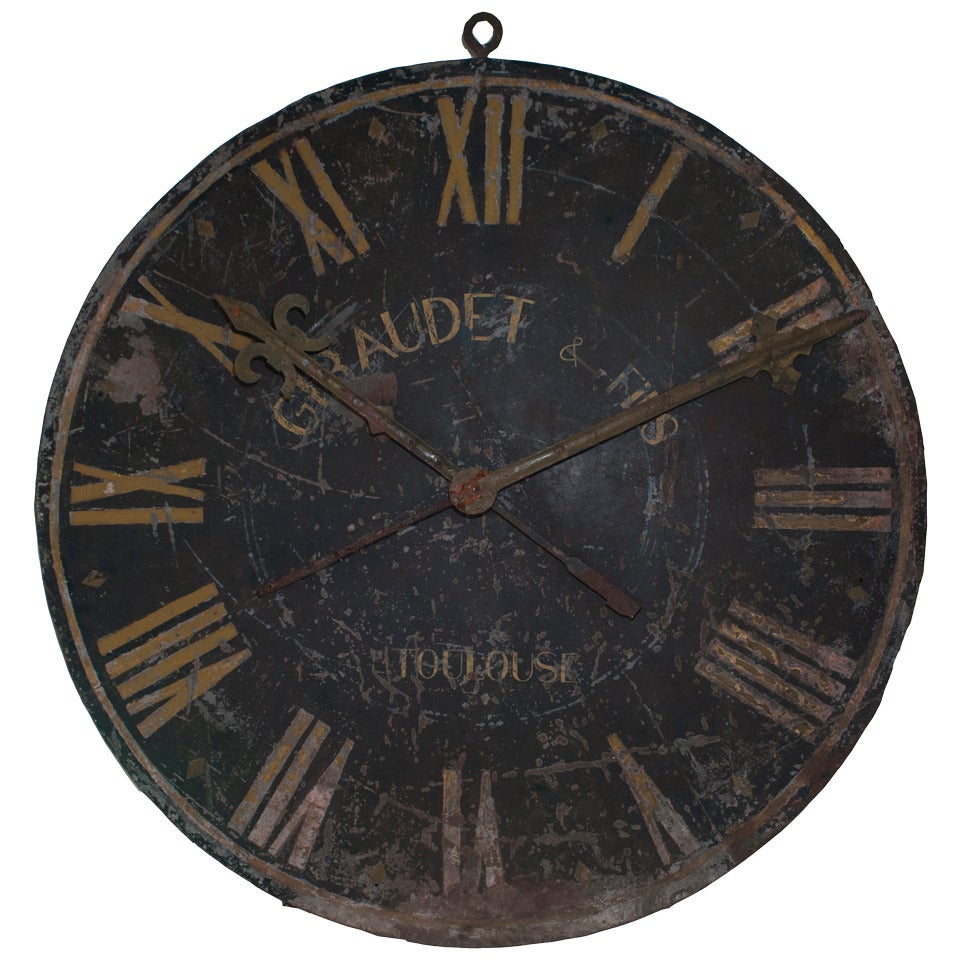 A very large wrought iron black and gold painted clock face.